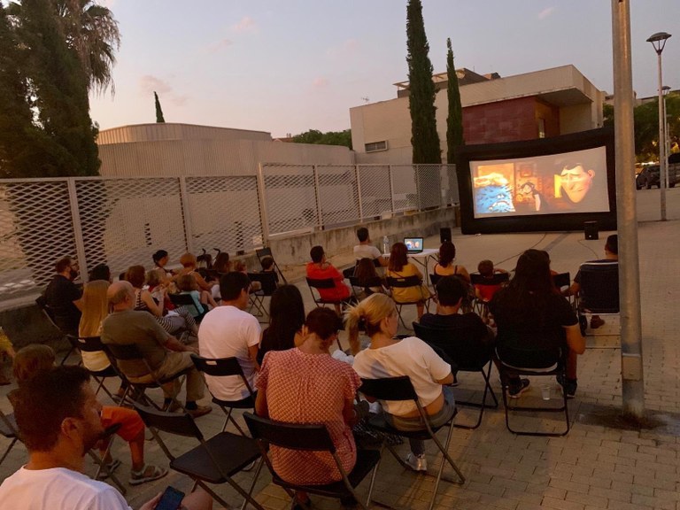 Families watching a movie at an outdoor cinema